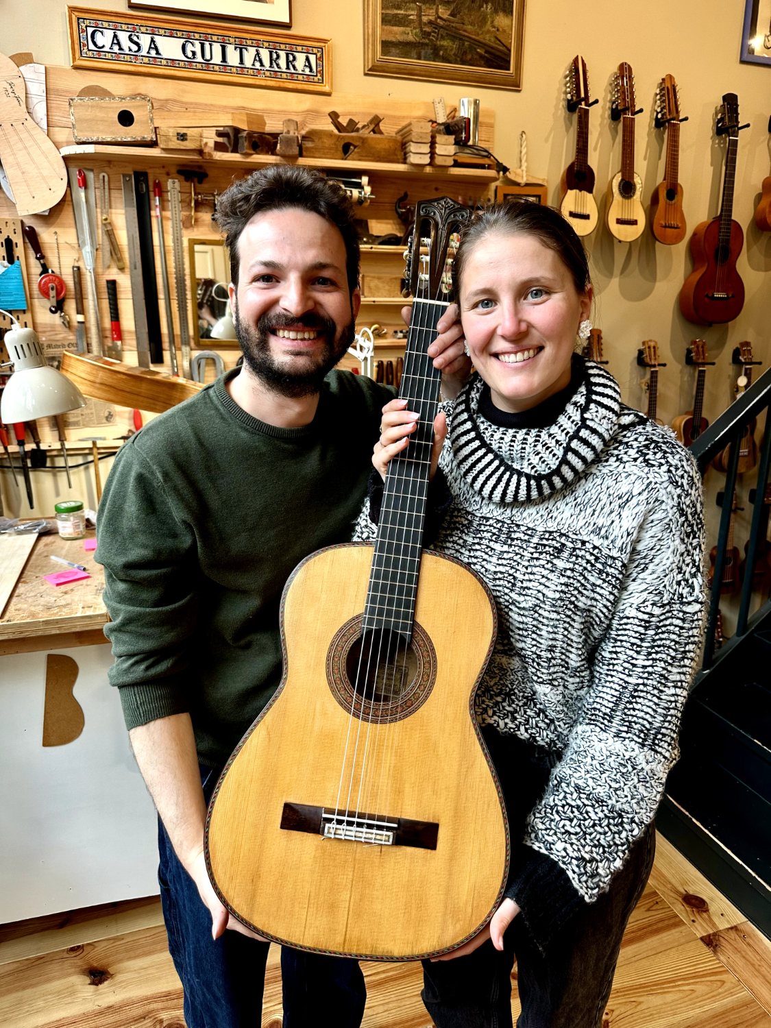 Ahmad Naffoury and Maria Torres with a guitar in the Casa Guitarra workshop