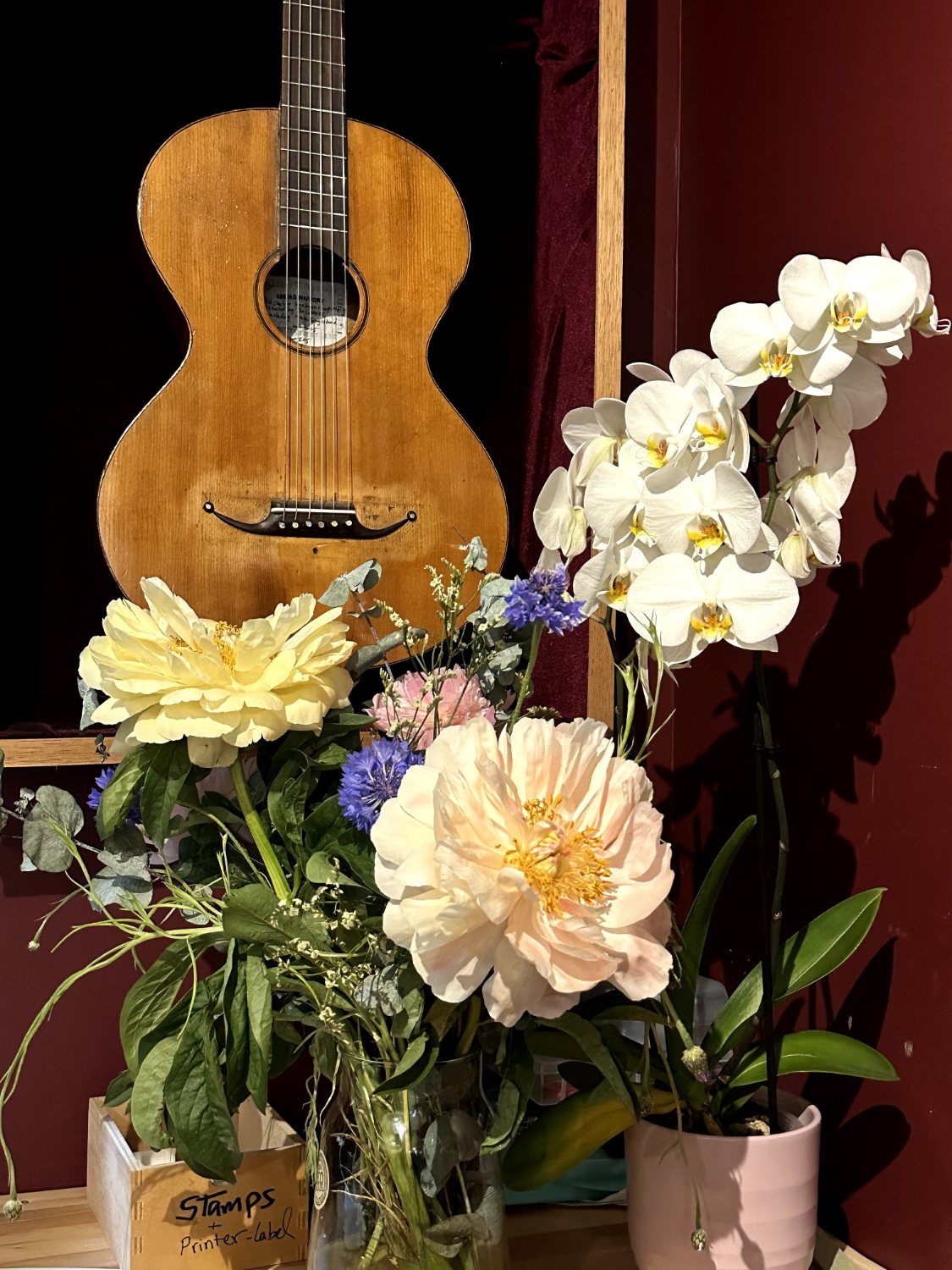 A guitar among flowers at Casa Guitarra in Amsterdam